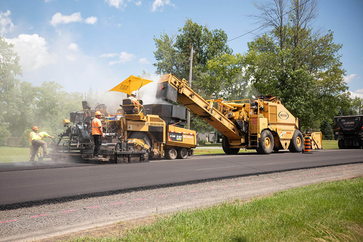 A.L. Blair construction doing road constructions by applying freshly new asphalt to the road
