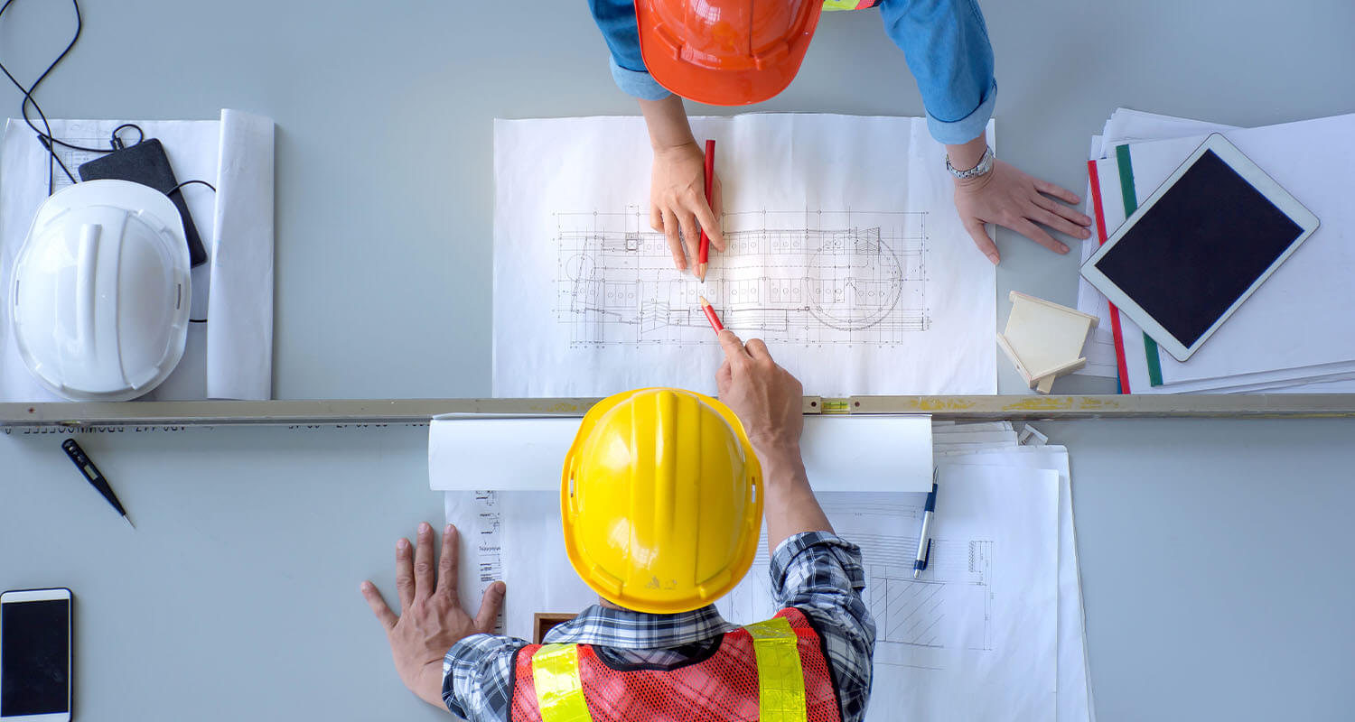 Top view of group of engineering team is meeting, planning construction work,looking paper plans at construction site,overhead view